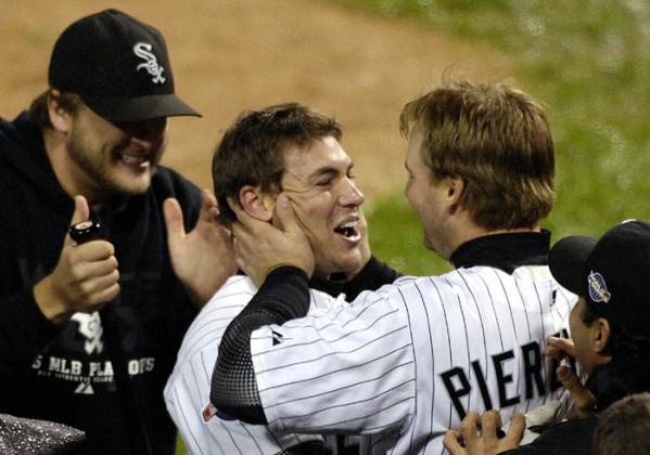 Chicago White Sox Scott Podsednik (L) celebrates at home plate with teammate A. J. Pierzynski (R) after hitting the winning home run off Houston Astros pitcher Brad Lidge during the ninth inning of game two of the World Series.