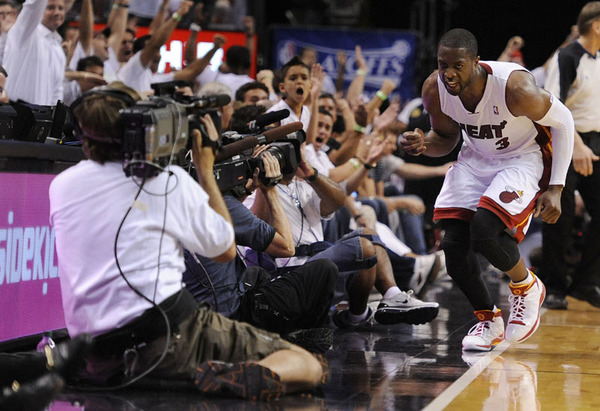 Miami Heat guard Dwyane Wade (celebrates after a three point shot against the Philadelphia 76ers during the fourth quarter of their Conference Quarterfinal round game five at the American Airlines Arena in Miami, Florida 