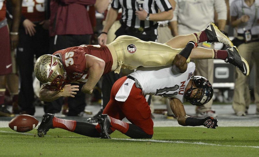  Florida State Seminoles Nick O'Leary (35) fumbles the ball against Northern Illinois Huskies Rashaan Melvin (11) during the Discover Orange Bowl NCAA football game at Sun Life Stadium in Miami, Florida.