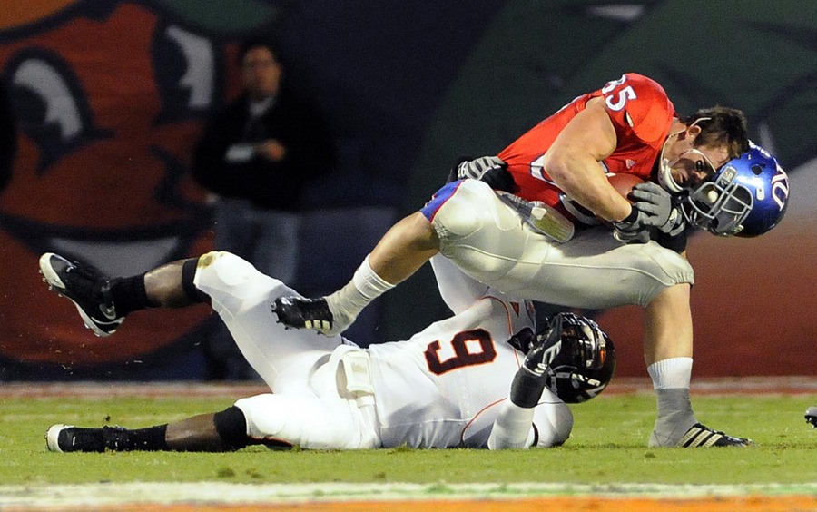  University of Kansas tight end Derek Fine (85) is tackled by Virginia Tech linebacker Vince Hall (9) during the Fed-Ex Orange Bowl at Dolphins Stadium in Miami, Florida