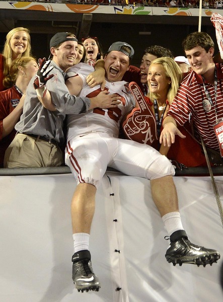 Alabama's Corey McCarron (47) celebrates with fans following the Alabama Crimson Tide versus Notre Dame Fighting Irish in the Discover BCS National Championship Game at Sun Life Stadium in Miami Gardens, Florida.