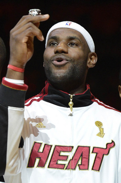 Miami Heat forward LeBron James looks at his championship ring during the ring ceremony prior to the start of their NBA basketball game against the Boston Celtics at the American Airlines Arena in Miami, Florida.