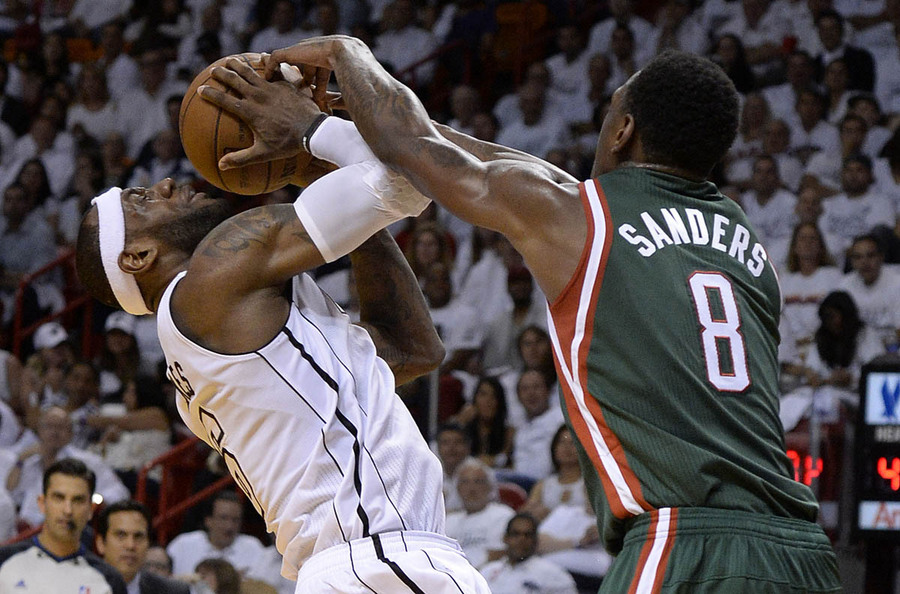 Miami Heat forward LeBron James (L) is defended by Milwaukee Bucks center Larry Sanders (R) during their NBA playoff basketball game at the American Airlines Arena in Miami, Florida USA 23 April 2013.