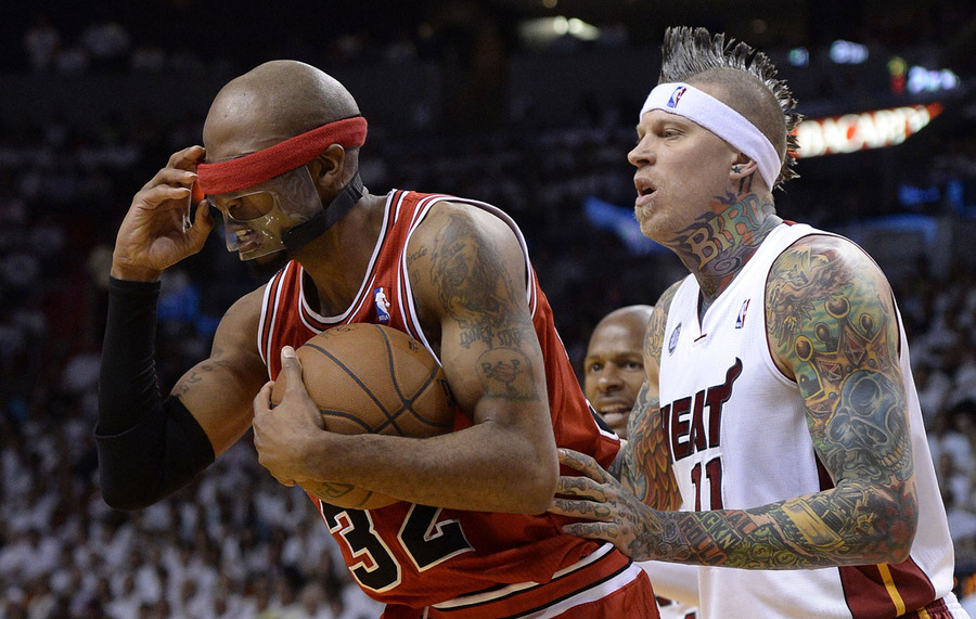 Chicago Bulls forward Richard Hamilton (L) tries to adjust his mask as he is defended by Miami Heat forward Chris Andersen (R) during their NBA playoff basketball game at the American Airlines Arena in Miami, Florida USA 15 May 2013. 