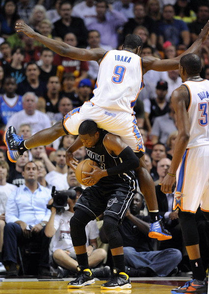 Oklahoma City Thunder's Serge Ibaka (top) lands on Miami Heat's Dwyane Wade during the second half of their NBA basketball game in Miami, Florida, April 4, 2012.