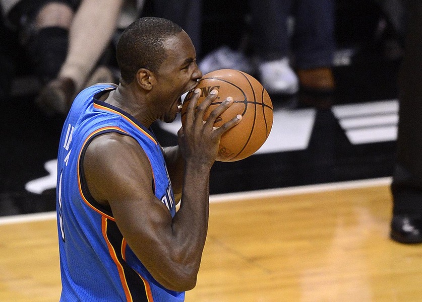 Oklahoma City Thunder forward Serge Ibaka bites the basketball after being called for a foul during the first half of game three of the NBA Finals against the Miami Heat at the American Airlines Arena in Miami, Florida USA, 17 June 2012