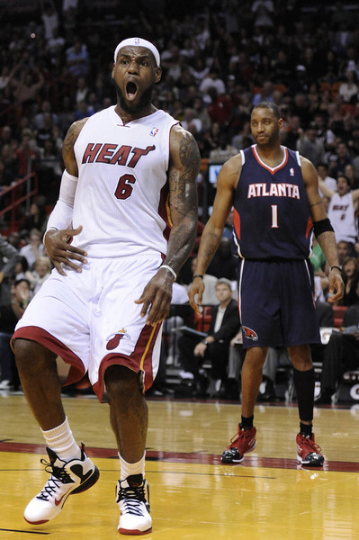 Miami Heat forward LeBron James (C) is defended by Indiana Pacers forward Corey Brewer and forward Anthony Tolliver (R) in their NBA  game in Miami, Florida January 04, 2012