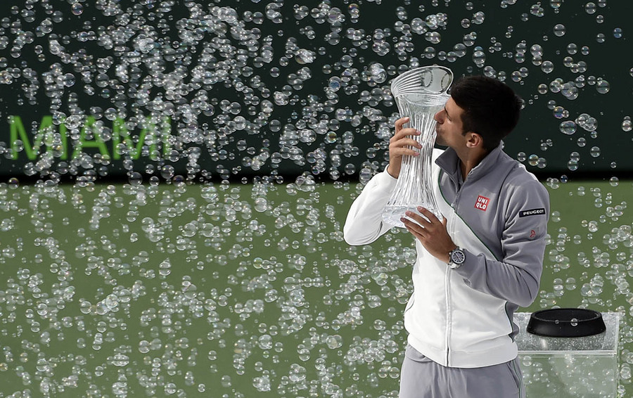 Novak Djokovic of Serbia kisses his trophy as he celebrates defeating Rafael Nadal of Spain following their men's singles final match at the Sony Open tennis tournament on Key Biscayne in Miami