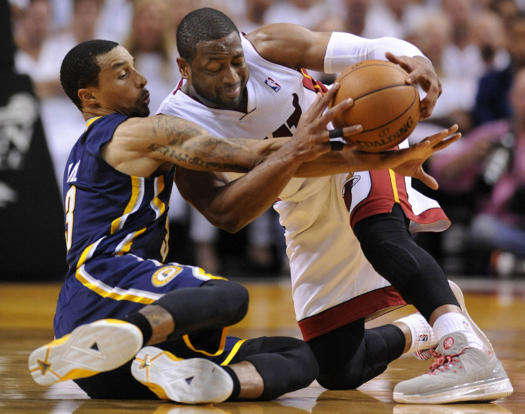 Miami Heat guard Dwyane Wade (R) battles for a loose ball with Indiana Pacers guard George Hill (L) during their Eastern Conference Finals NBA playoff game at the American Airlines Arena in Miami, Florida