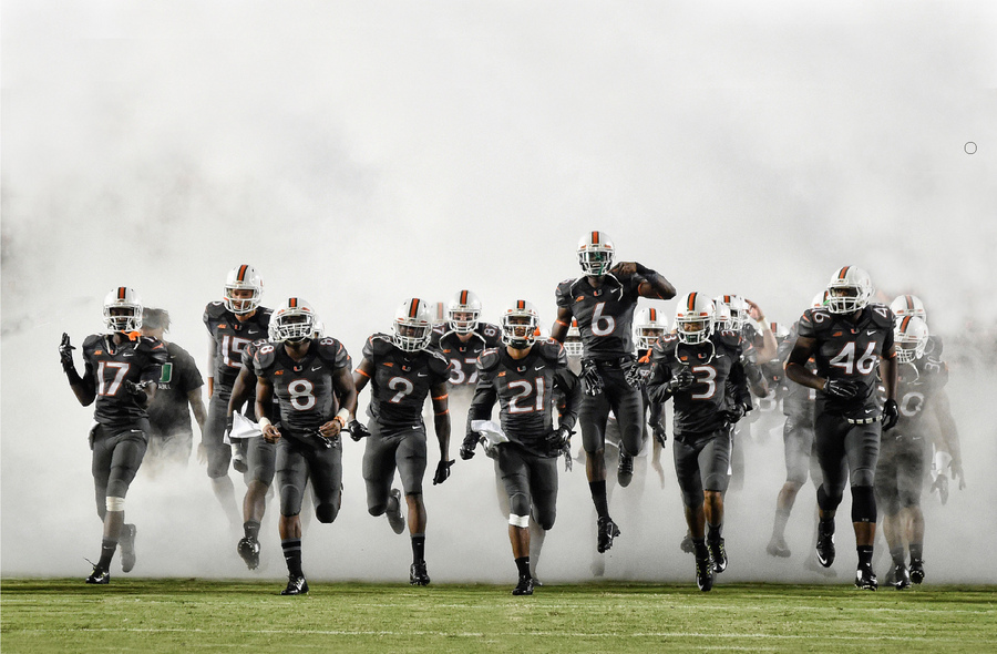 University of Miami player enter the field through smoke prior to their game at Sun Life Stadium in Miami.