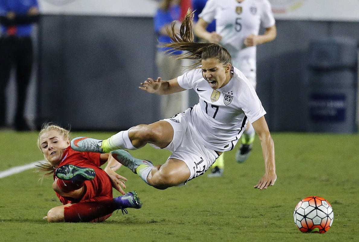 USA's Tobin Heath (R) falls as she collides with England's Alex Greenwood (L) during their first round SheBelieves Cup soccer match March 3, 2016 in Tampa, Florida.