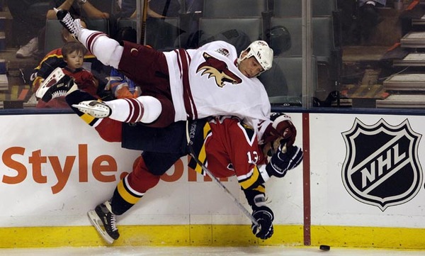 Phoenix Coyotes defenseman Ed Jovanovski (Top) lchecks Florida Panthers right wing Juraj Kolnik (bottom) during the first period of their game at the BankAtlantic Centerin Sunrise, Florida. 