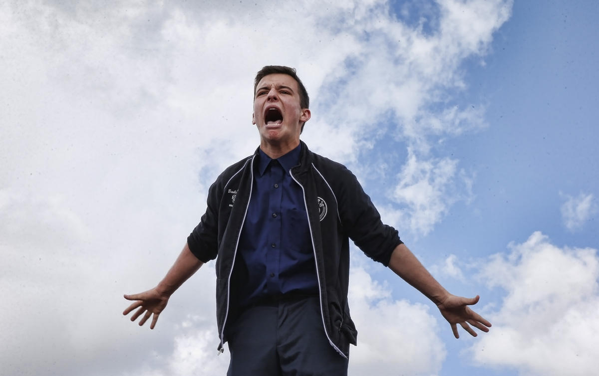 Majory Stoneman High School student Cameron Kasky reacts as he addresses area High Schoolstudents as they rally at Marjory Stoneman Douglas High School after participating in a county wide school walk out in Parkland, Florida on February 21, 2018. 