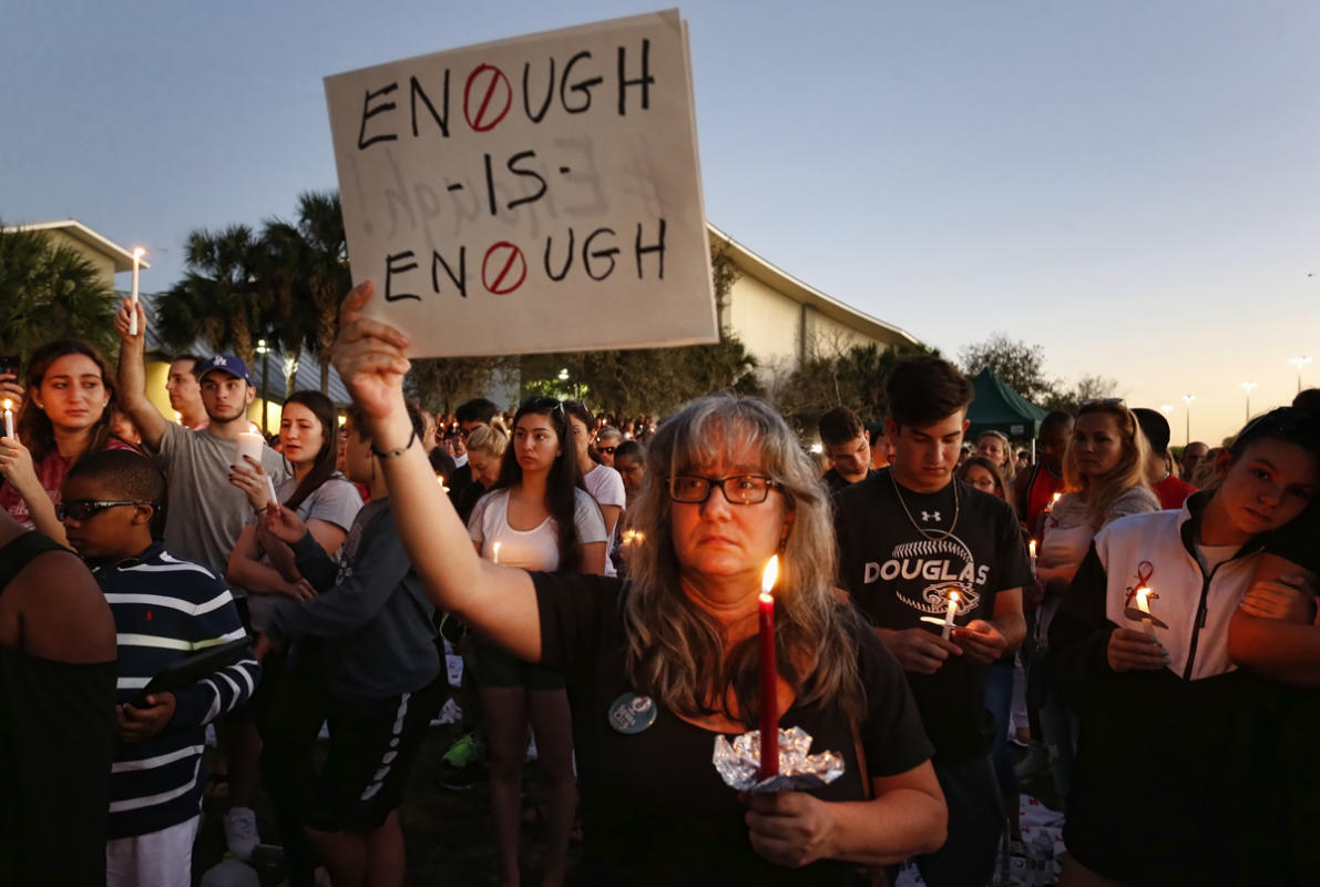 Mourners stand during a candlelight vigil for the victims of Marjory Stoneman Douglas High School shooting in Parkland, Florida on February 15, 2018. 