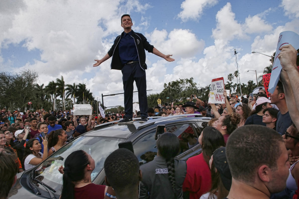 Majory Stoneman High School student Cameron Kasky addresses area High Schoolstudents as they rally at Marjory Stoneman Douglas High School after participating in a county wide school walk out in Parkland, Florida on February 21, 2018. 