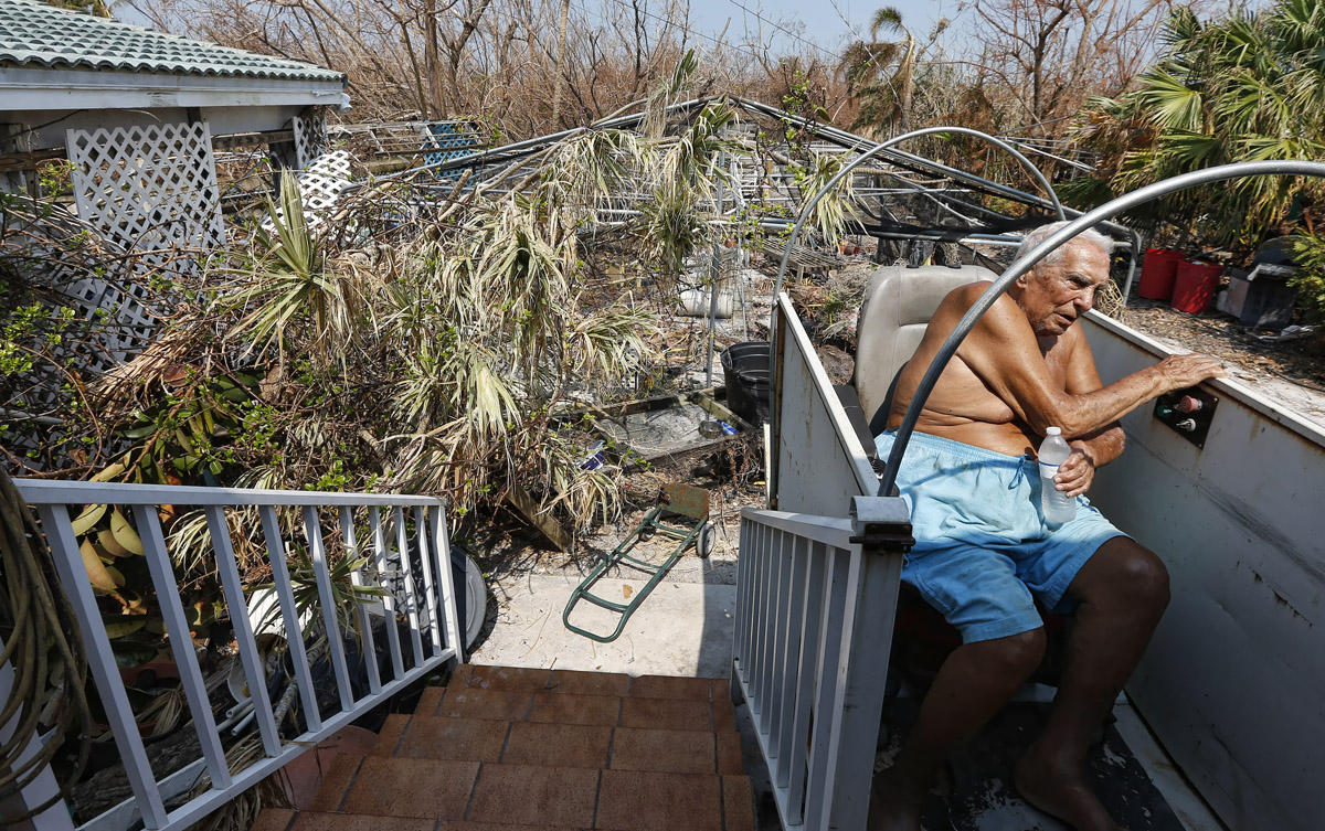 Veteran Wes Harris, 85, rides his wheelchair lift back to his home after riding through a path cleared by first responders in front of his home after Hurricane Irma after struck the Florida Keys on Big Pine Key, Florida, USA, 20 September 2017. Harris, who rode out the storm with his 85 year old wife who could not be moved because of dementia, lost his shade houses and his livelihood of almost 8000 orchids.