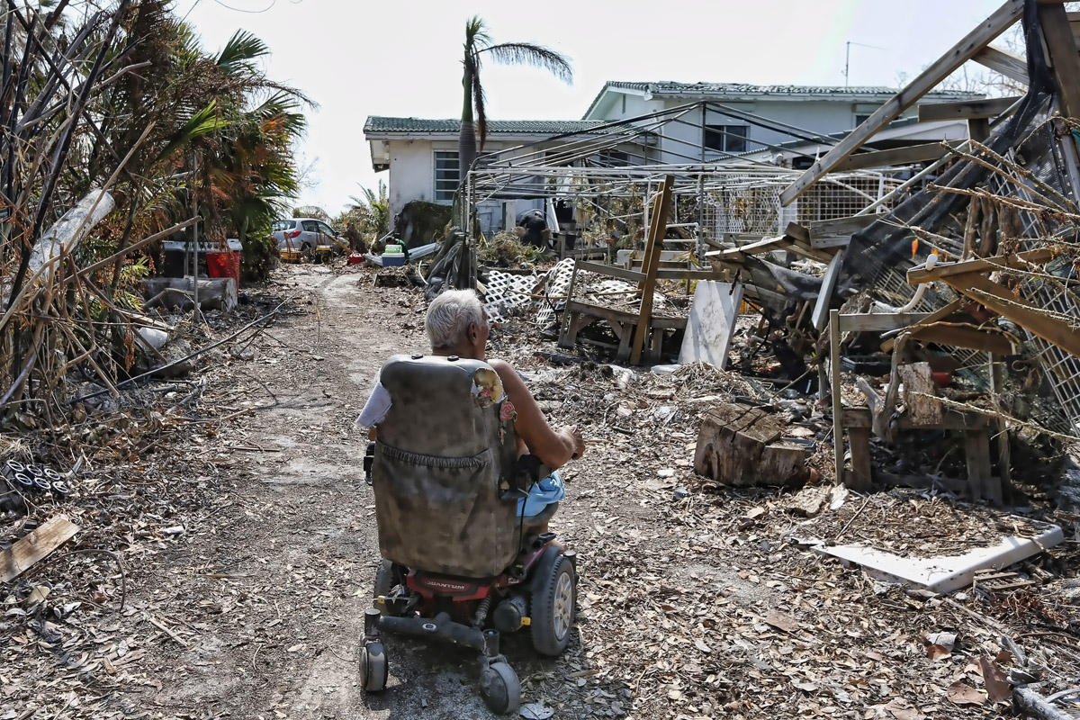 Veteran Wes Harris, 85, takes his wheelchair through a path cleared by first responders in front of his home after Hurricane Irma after struck the Florida Keys on Big Pine Key, Florida, USA, 20 September 2017. Harris, who rode out the storm with his 85 year old wife who could not be moved because of dementia, lost his shade houses and his livelihood of almost 8000 orchids.