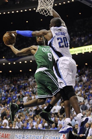 Boston Celtics guard Rajon Rondo (L) is fouled by Orlando Magic forward Mickael Pietrus (R) during game six of their Eastern Conference semifinals playoff game at the Amway Arena in Orlando, Florida