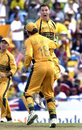 Australian bowler Brad Hogg celebrates with teammate Adam Gilchrist after dismissing Sri Lankan batsman Kumar Sangakkara during the 2007 ICC Cricket World Cup final match at the Kensingston Oval in Bridgetown, Barbados, Saturday, April 28, 2007. Australia defeated Sri Lanka by 53 runs to win an unprecedented third straight Cricket World Cup title.