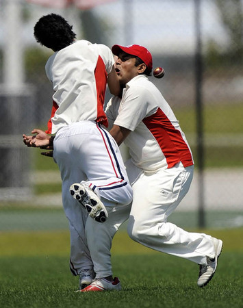 Boston University Sumantro Das (R) collides with a teammate trying to make a catch on a batted ball during the game against the University of Miami during the American College Spring Break Cricket Championship in Lauderhil,l Florida 22 March 2009. 