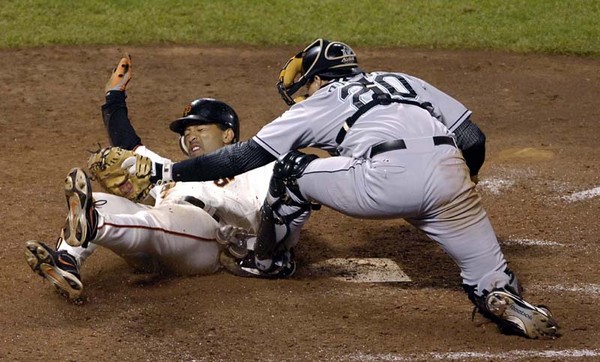 San Francisco Giants Dave Roberts (L) slides in under the tage of Florida Marlins catcher Matt Treanor (R) after Mark Sweeney hit a double to tie the game against Florida Marlins pitcher Kevin Gregg in the nineth  inning at AT&T Park in San Francisco, California, USA, 28 July 2007. 