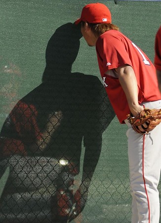 Boston Red Sox pitcher Daisuke Matsuzaka looks through the scsreen to watch another field as he paricipates in drills during spring training at the Red Sox training facilty in Fort Myers, Florida USA 16 February 2008. 