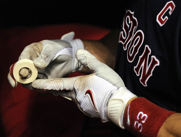 Boston Red Sox captain and catcher Jason Varitek tapes his fingers during batting practice prior to the start of game six of the American League Championship Series against the Tampa Bay Rays at Tropicana Field in St. Petersburg, Florida, USA, 18 October 2008. 