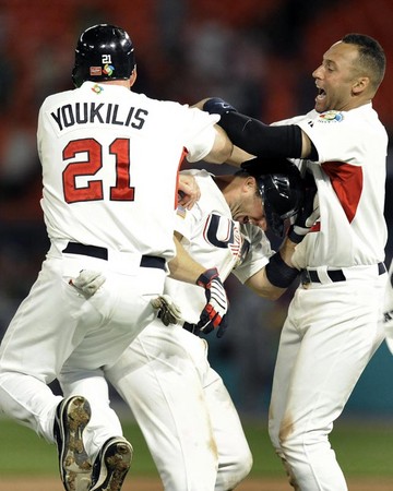 USA's Kevin Youkilis (L) and Derek Jeter (R) celebrate with teammate David Wright (C) after Wright hit the game winning single defeating Puerto Rico following game five of round two, pool two of the World Baseball Classic at Dolphin Stadium in Miami, Florida 17 March 2009.