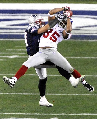 New York Giants David Tyree makes a 32 yard card catch around the defense of New England Patriots Rodney Harrison during the fourth quarter of Super Bowl XLII at the University of Phoenix Stadium in Glendale, Arizona.