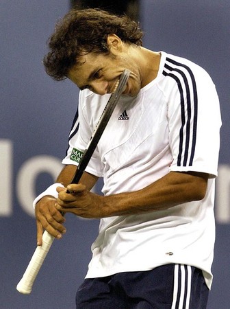 Mariano Zabaleta of Argentina bites his raquet after losing a point to James Blake of the USA during their second round match at the US Open in Flushing Meadows, New York.