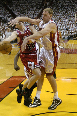 Miami Heat Michael Doleac (R) fouls Chicago Bulls guard Kirk Hinrich (L) during the second half of their first round Eastern Conference playoff game at the American Airlines Arena in Miami, Florida 