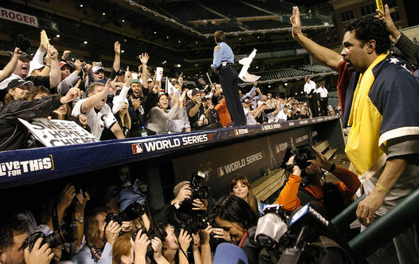 Chicago White Sox manager Ozzie Guillen waves to the fans as he exits the field after the White Sox defeated the Houston Astros to win game four and a sweep of the World Series at Minute Maid Park in Houston, Texas