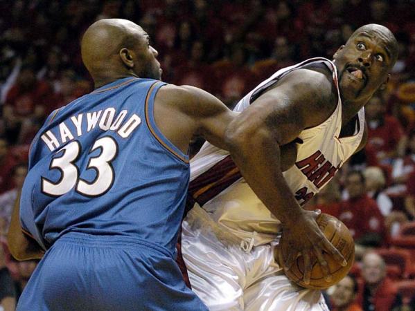 Miami Heat center Shaquille O'Neal is fouled by Washington Wizards center Brendan Haywood during the first half of their eastern conference semifinal playoff game at the American Airlines Arena in Miami, Florida.