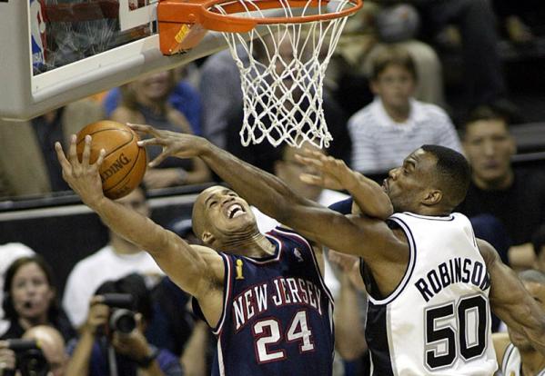 San Antonio Spurs David Robinson (R) knocks the ball away from New Jersey Nets Richard Jefferson during first quarter of the NBA Finals game one at the SBC Center  in San Antonio, Texas.