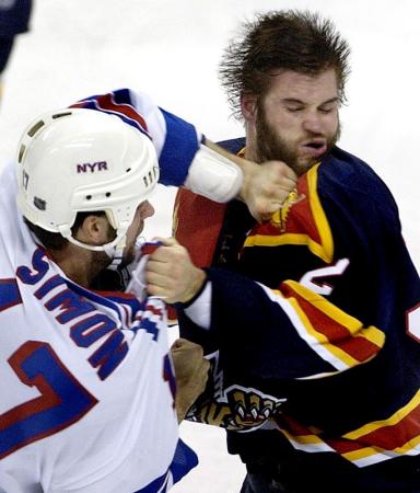 New York Rangers' Chris Simon (L) lands a punch against Florida Panthers' Grant McNeil (R) during the first period of their game at the Office Depot Center in Sunrise, Florida.