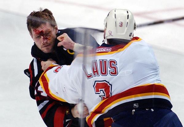 Chicago Blackhawks Bob Probert (L) fights with Florida Panthers Paul Laus during their game at the Office Depot Center in Sunrise, Florida.