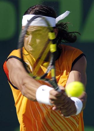 Rafael Nadal of Spain returns the ball to compatriot David Ferrer during their semifinal match at the Nasdaq-100 Open in Key Biscayne, Florida.