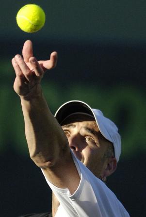 Andre Agassi of the US serves to Gaston Gaudio of Argentina during their fourth round match at the Nasdaq-100 Open in Key Biscayne, Florida.