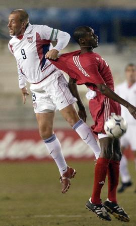 US forward and team captain Clint Mathis (L) and Canada's Atiba Hutchinson (R) miss a header in the first half of their friendly match at Lockhart Stadium in Fort Lauderdale, Florida.