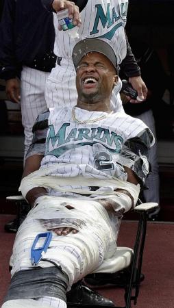 Florida Marlins' 30 year old rookie Pitcher Chuck Smith gets a bath from a teammate as he sits taped to a chair in front of the dugout before the game against the  Philadelphia Phillies at Pro Player Stadium in Miami, Florida.