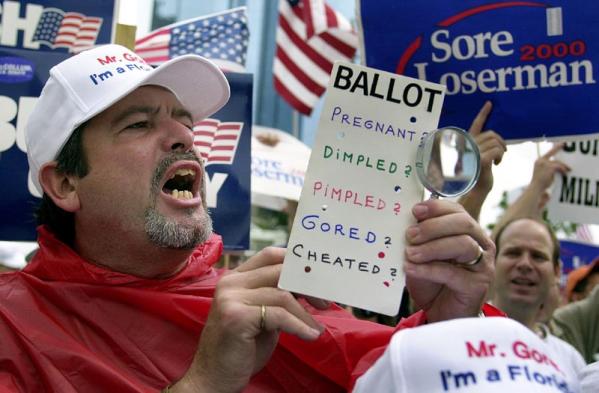  Bush-Cheney supporter Joseph Dominguez holds a mock ballot and chants 'President Bush' 25 November 2000 in front of the Broward County Courthouse in Ft. Lauderdale, Florida. Florida will be closely watched in the 2004 presidential election as a results of voting controversies throughout the state during the 2000 election