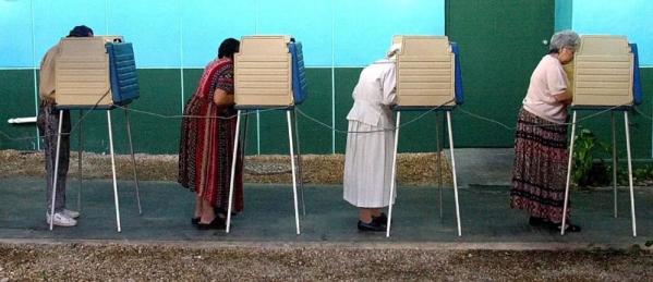 Cuban American women vote at pollng center in Little Havana, a hispanic neighborhood in Miami, Florida 07 November 2000. Florida will be closely watched in the 2004 presidential election as a results of voting controversies throughout the state during the 2000 election