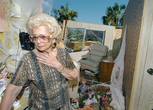 A Woman reacts to her home being destroyed by Hurricane Charley in Punta Gorda, Florida, Sunday 15 August 2004. Charley, a category 4 hurricane with sustained winds of 145 miles per hour swept through the west coast of Florida 13 August leaving millions of dollars in damage in it's wake.