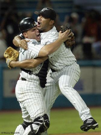 Florida Marlins' catcher Ivan Rodriguez (L) and pitcher Ugueth Urbina celebrate the final out and the teams' win over the New York Mets to clinch the National League Wild Card spot at Pro Player Stadium In Miami, Florida.