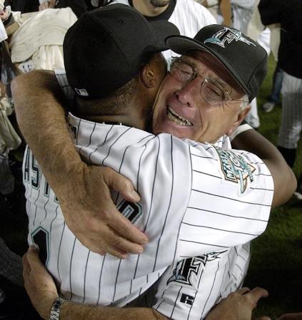 Florida Marlins' Manager Jack McKeon (R) and second baseman Luis Castillo (L) celebrate on the field after the Marlins win over the New York Mets to clinch the National League Wild Card spot at Pro Player Stadium in Miami, Florida.