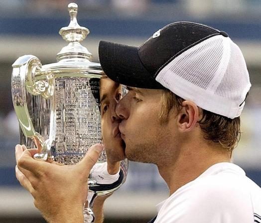Andy Roddick of the US kisses the US Open trophy after defeating Juan Carlos Ferrero of Spain in the men's final Sunday 07 September, 2003 at the US Open in Flushing Meadows, New York