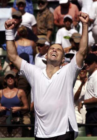 Andre Agassi of the US throws his arms up in the air as he celebrates defeating Roger Federer of Switzerland during their Men's Singles final match in the Masters Series tennis tournament in Key Biscayne, Florida.