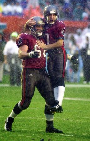 Tampa Bay Bucs kicker Martin Gramatica (R) celebrates with teammate Jeff Christy (L) after he kicked the game winning 46 yard field goal in the rain during the 4th quarter of their game against the Miami Dolphins at Pro Player Stadium in Miami, Florida.