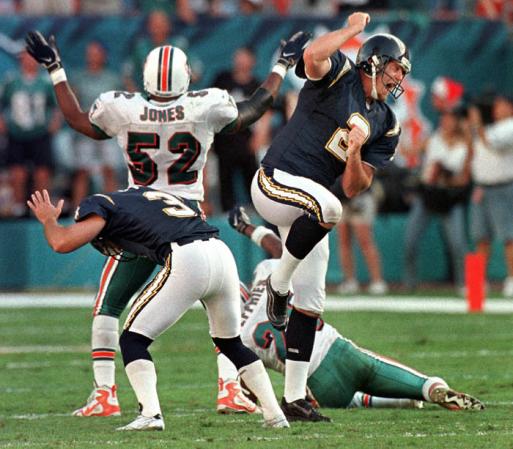 Miami Dolphins linebacker Robert Jones  celebrates as San Diego kicker John Carney (L) and holder Darren Bennett (R) react after Carney missed a game tying field with 5 seconds left in the game at Pro Player Stadium in Miami, Florida