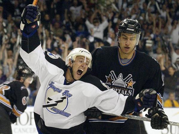 Tampa Bay Lightnings' Vaclay Prospal (L) celebrates his goal in front of Washington Capitals Jaromir Jagr (behind) Dainius Zubrus (R) during their second game in round one of the Stanley Cup Finals at the St. Pete Times Forum in Tampa, Florida.